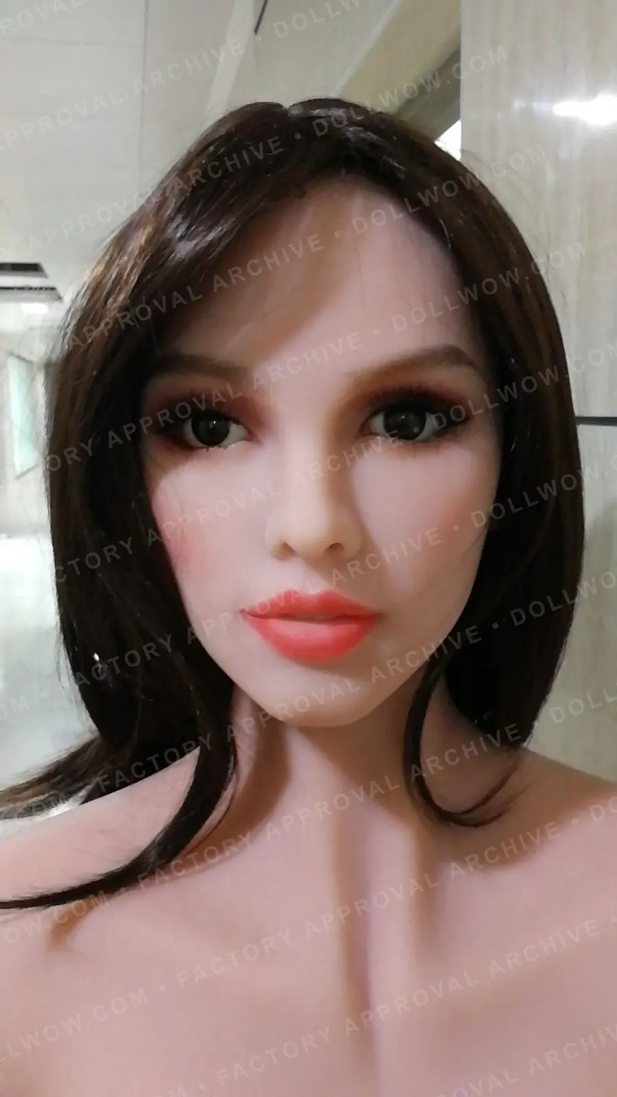 Anonymized historical factory photo showing a completed doll build for visible configuration review.